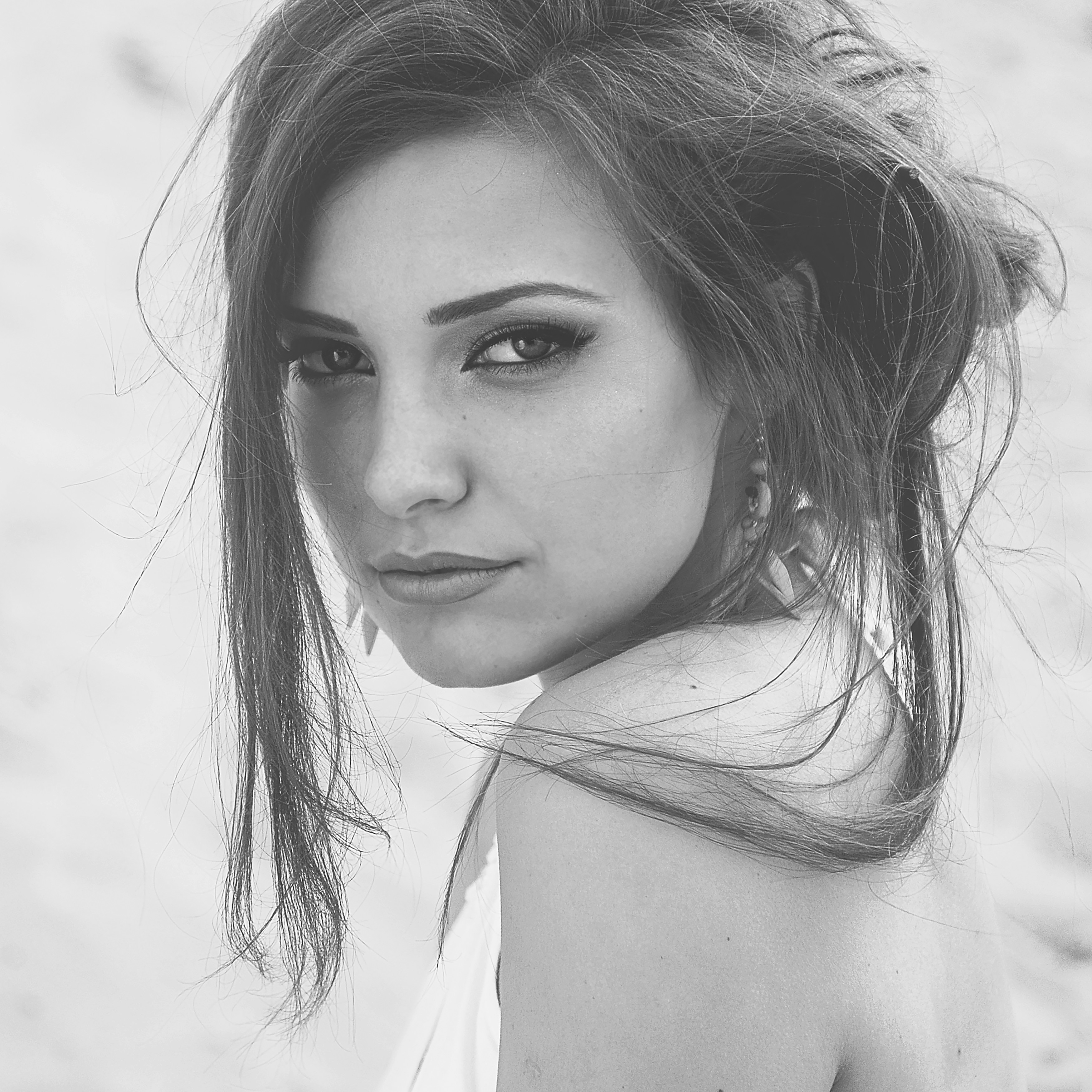 A black and white photo of a woman on the beach
