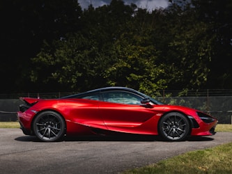 A red sports car parked on the side of a road