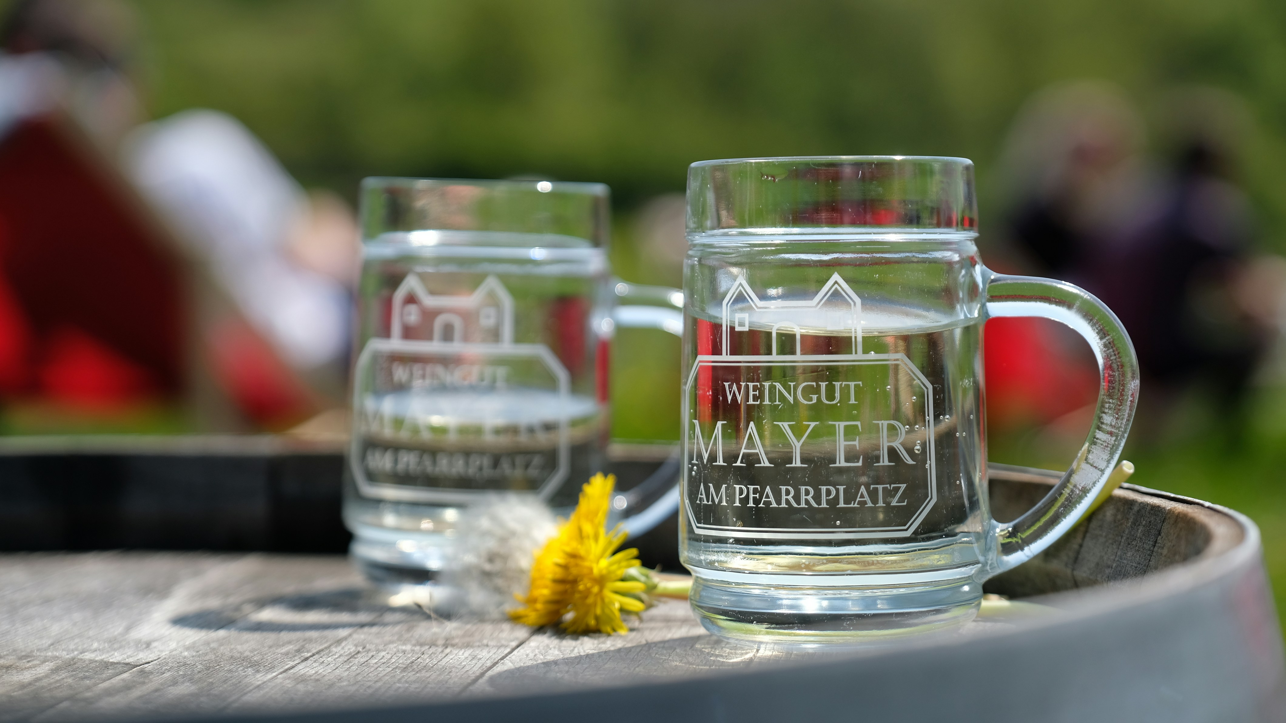 A couple of glasses sitting on top of a barrel