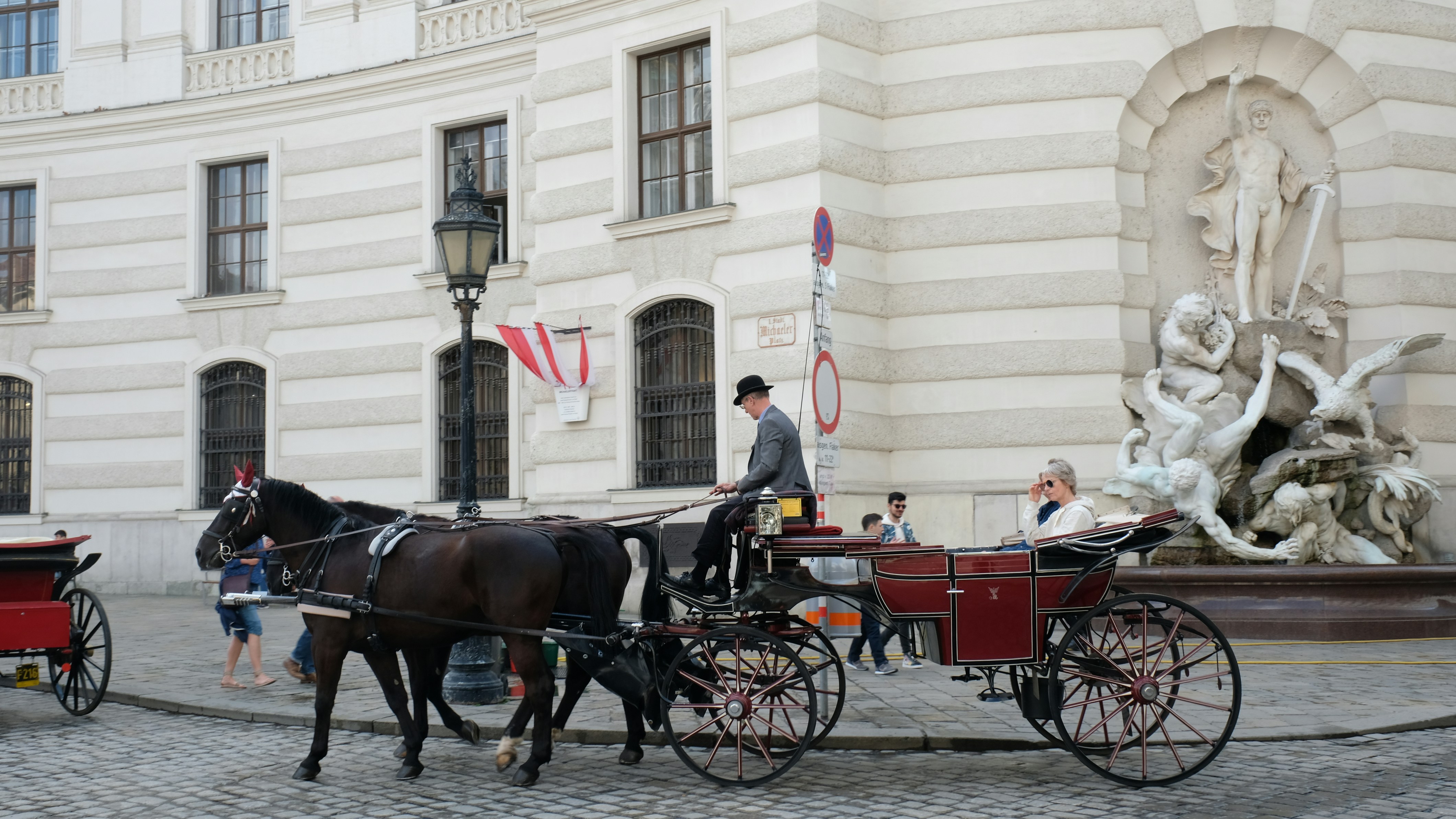A horse drawn carriage on a cobblestone street