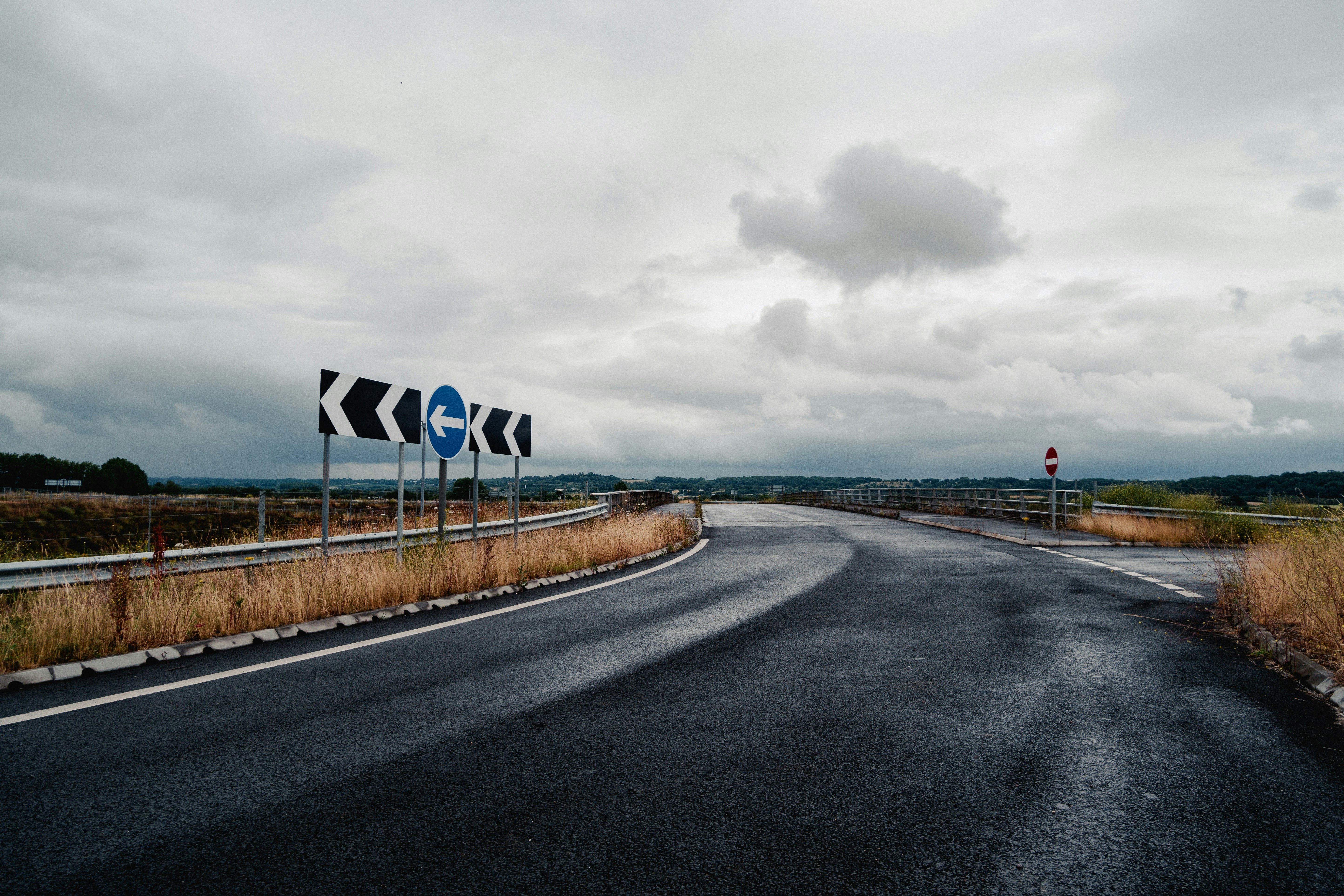 A road with a bunch of signs on the side of it
