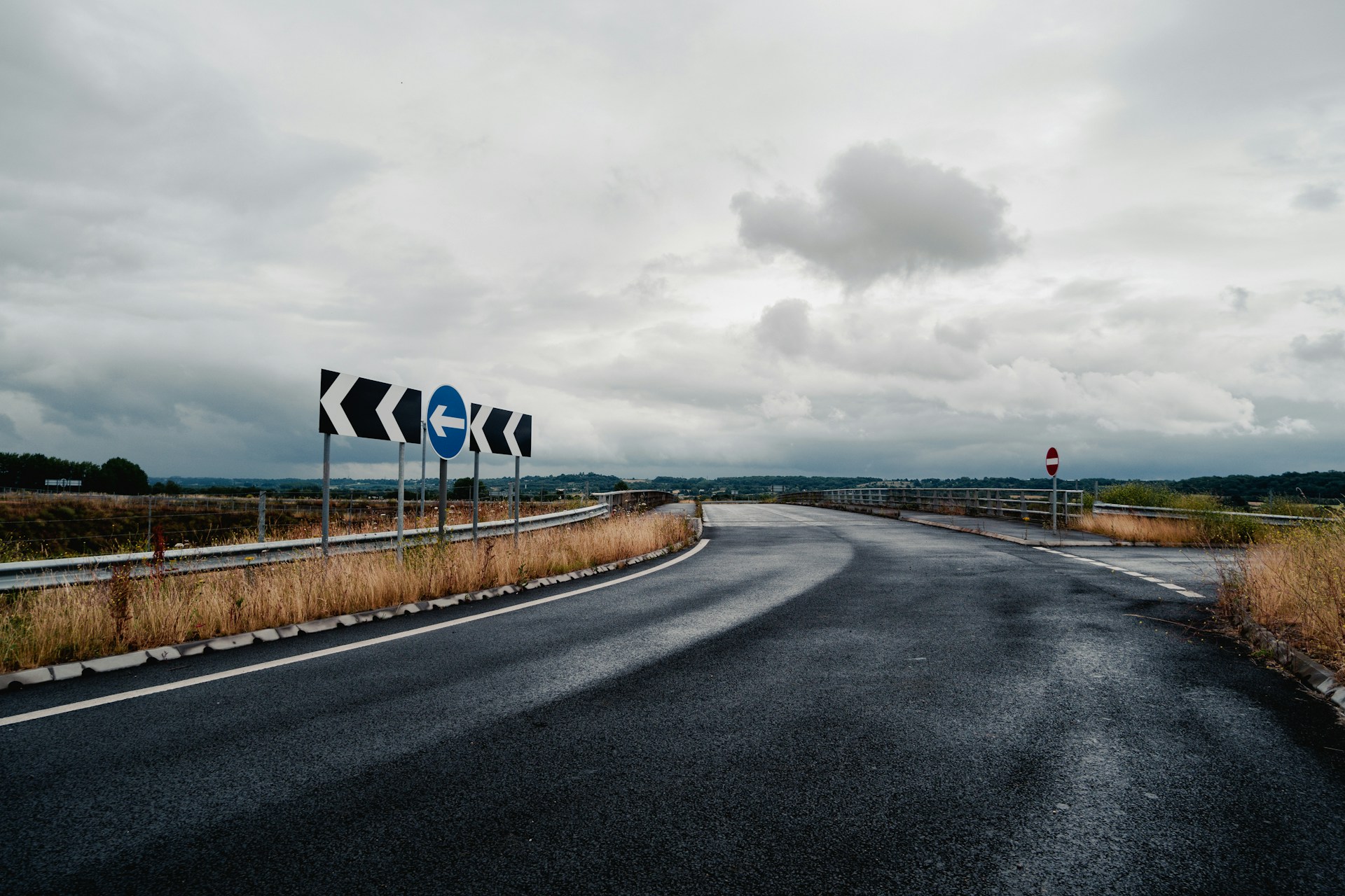 A road with a bunch of signs on the side of it