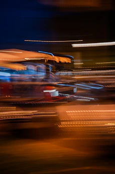 A blurry photo of a bus at night