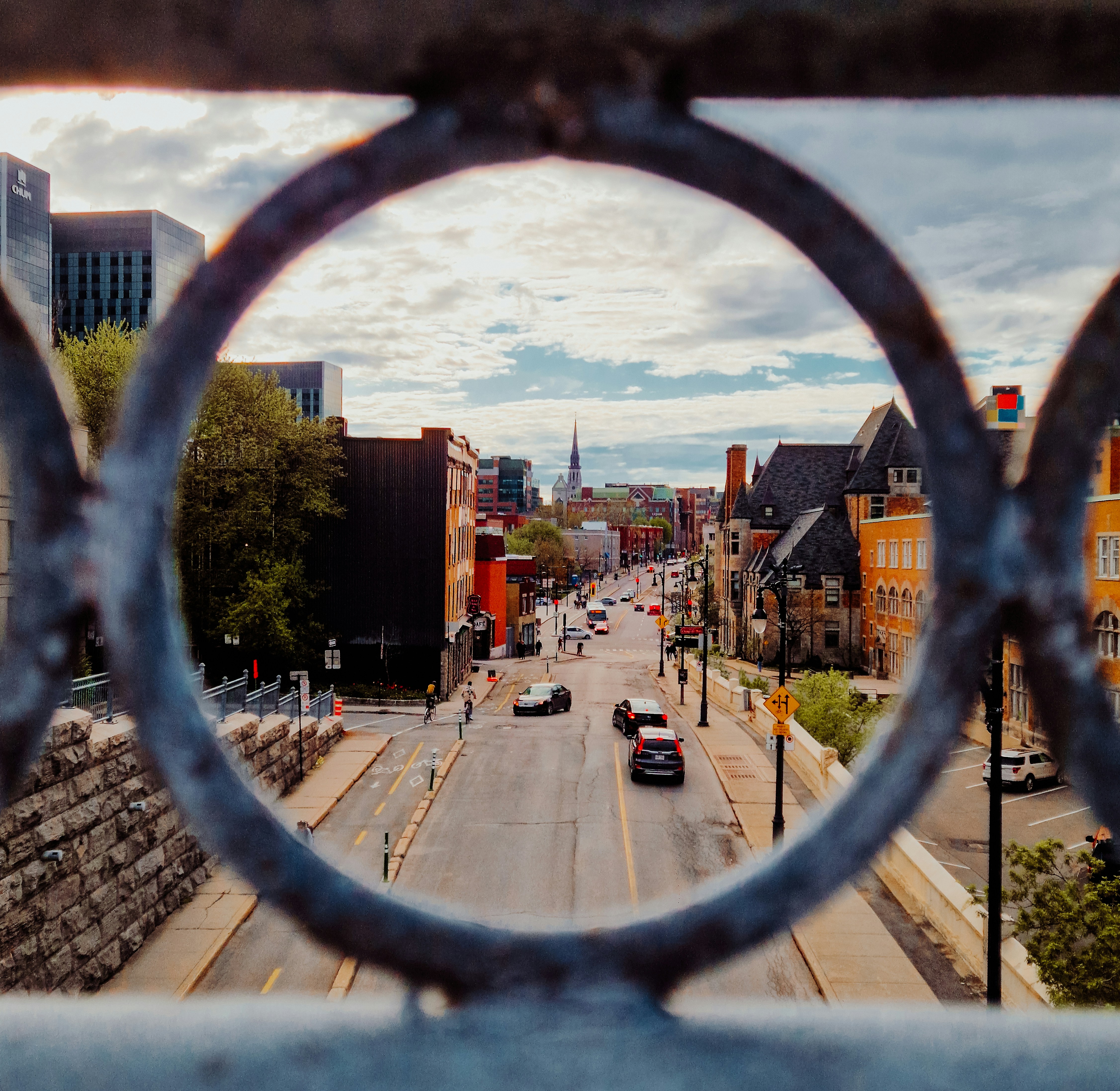 A view of a street through a fence