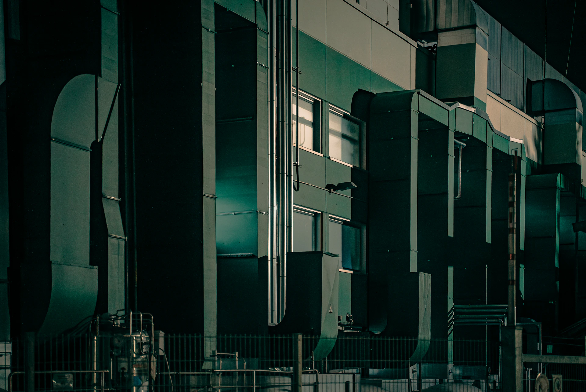 A room filled with lots of tall green and white appliances