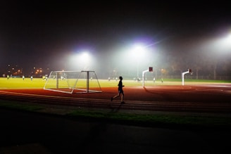 A person running on a track at night