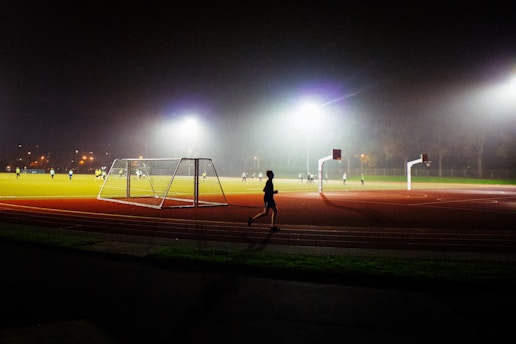 A person running on a track at night