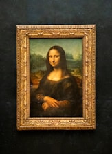 A painting of a woman in a gold frame