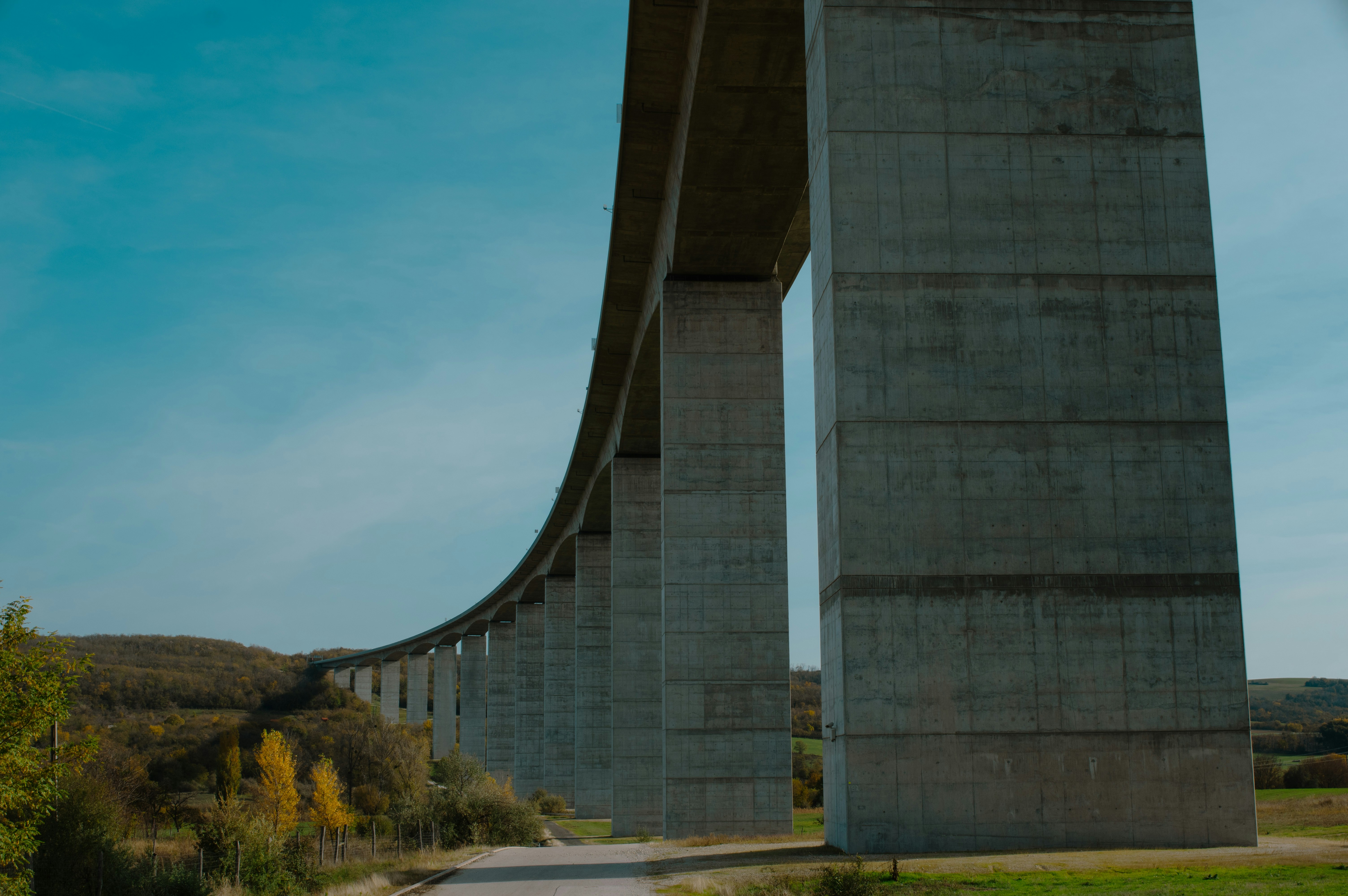 A large bridge spanning over a lush green field