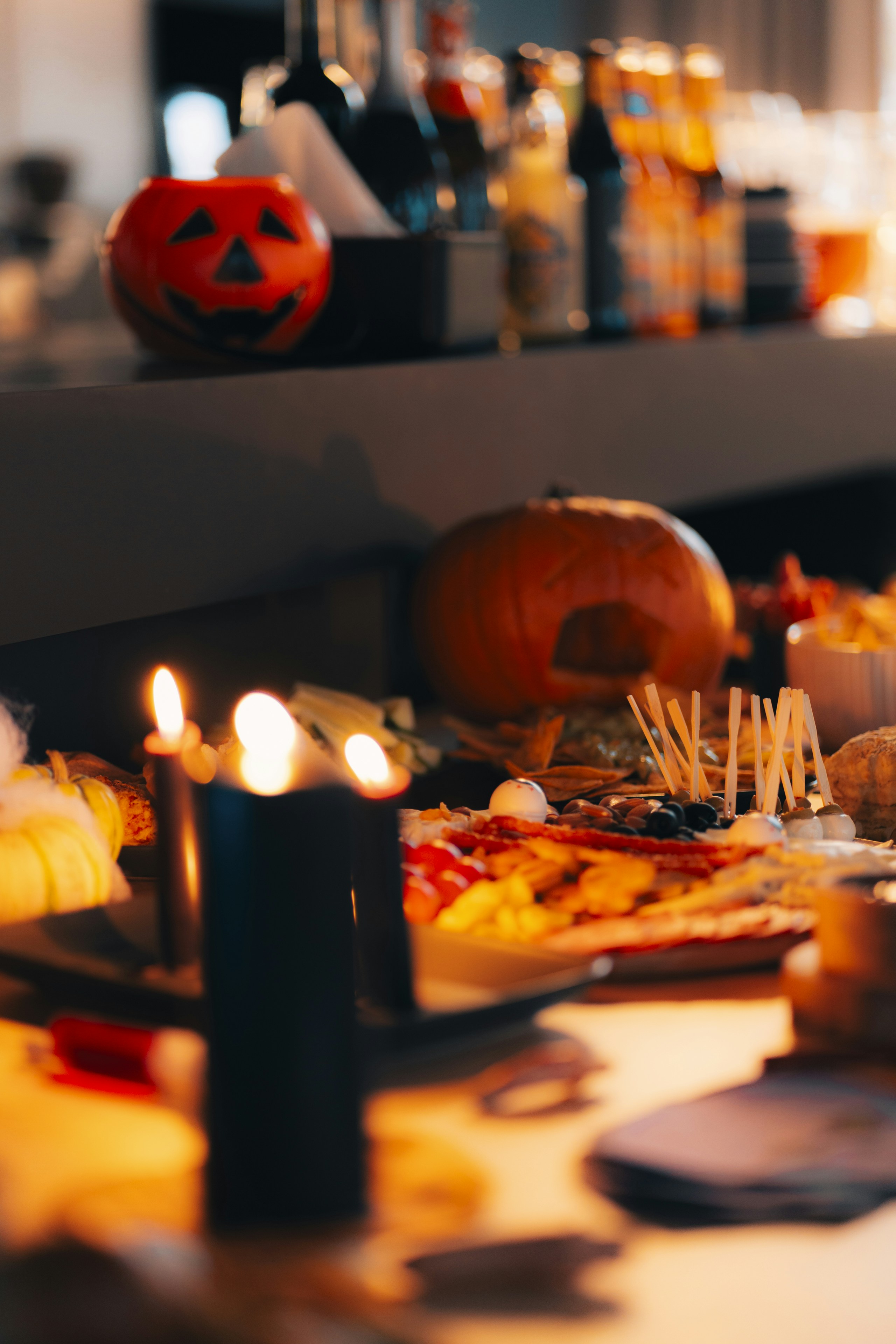 A table topped with lots of food and candles