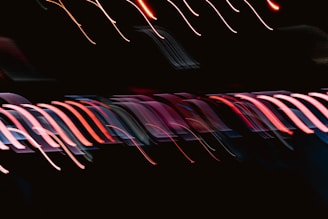 A blurry photo of a black background with red and pink lights