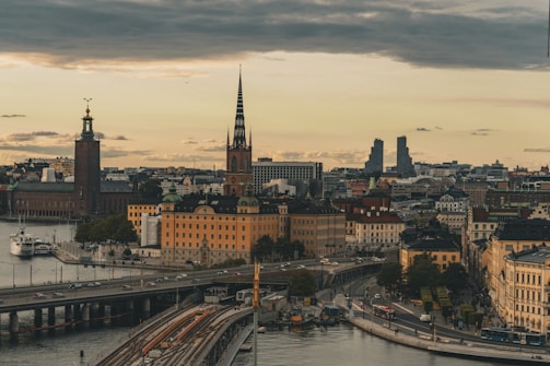 A view of a city with a bridge in the foreground