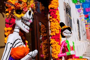 A couple of skeletons that are standing in front of a building