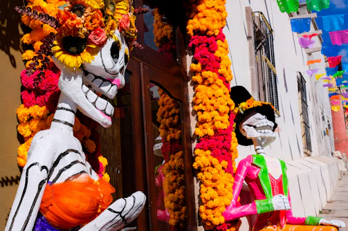 A couple of skeletons that are standing in front of a building