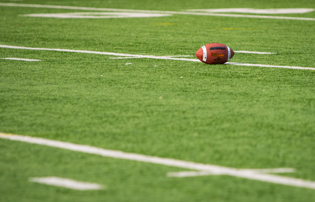 American football lying on a marked field
