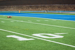A football field with a goalie laying on it