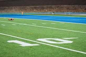 A football field with a goalie laying on it