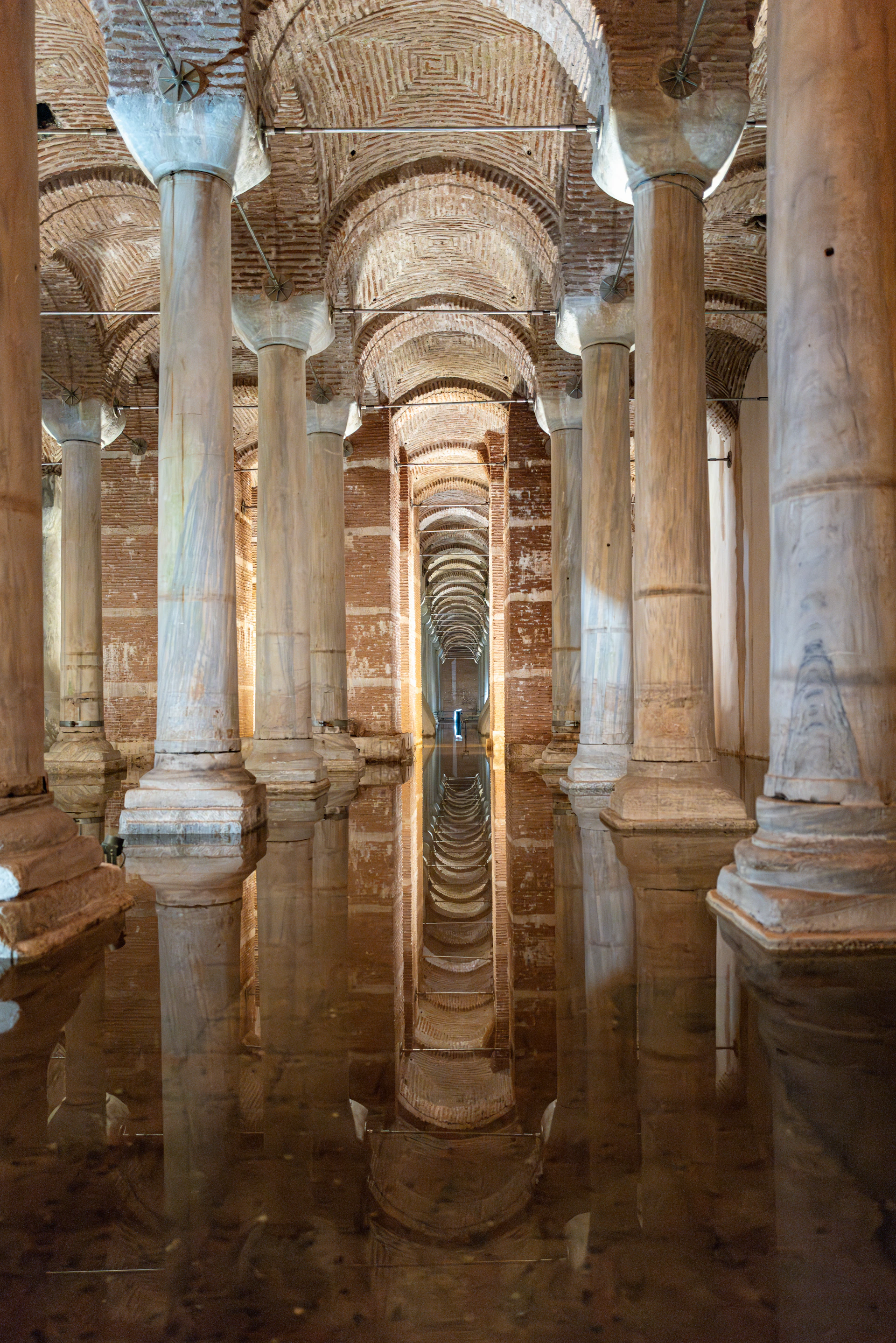 A large room with columns and a water feature