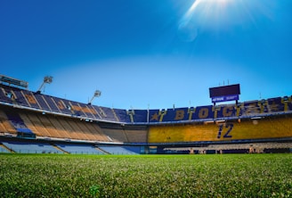 A stadium filled with lots of green grass