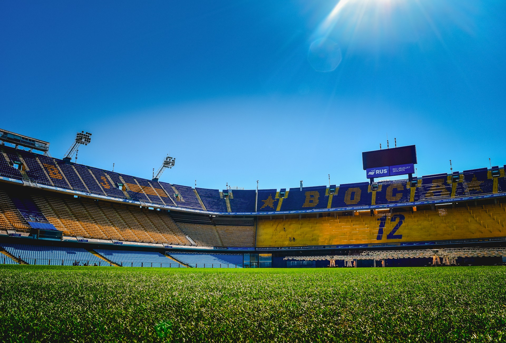 A stadium filled with lots of green grass