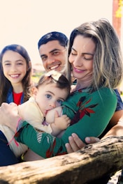A family of three posing for a picture