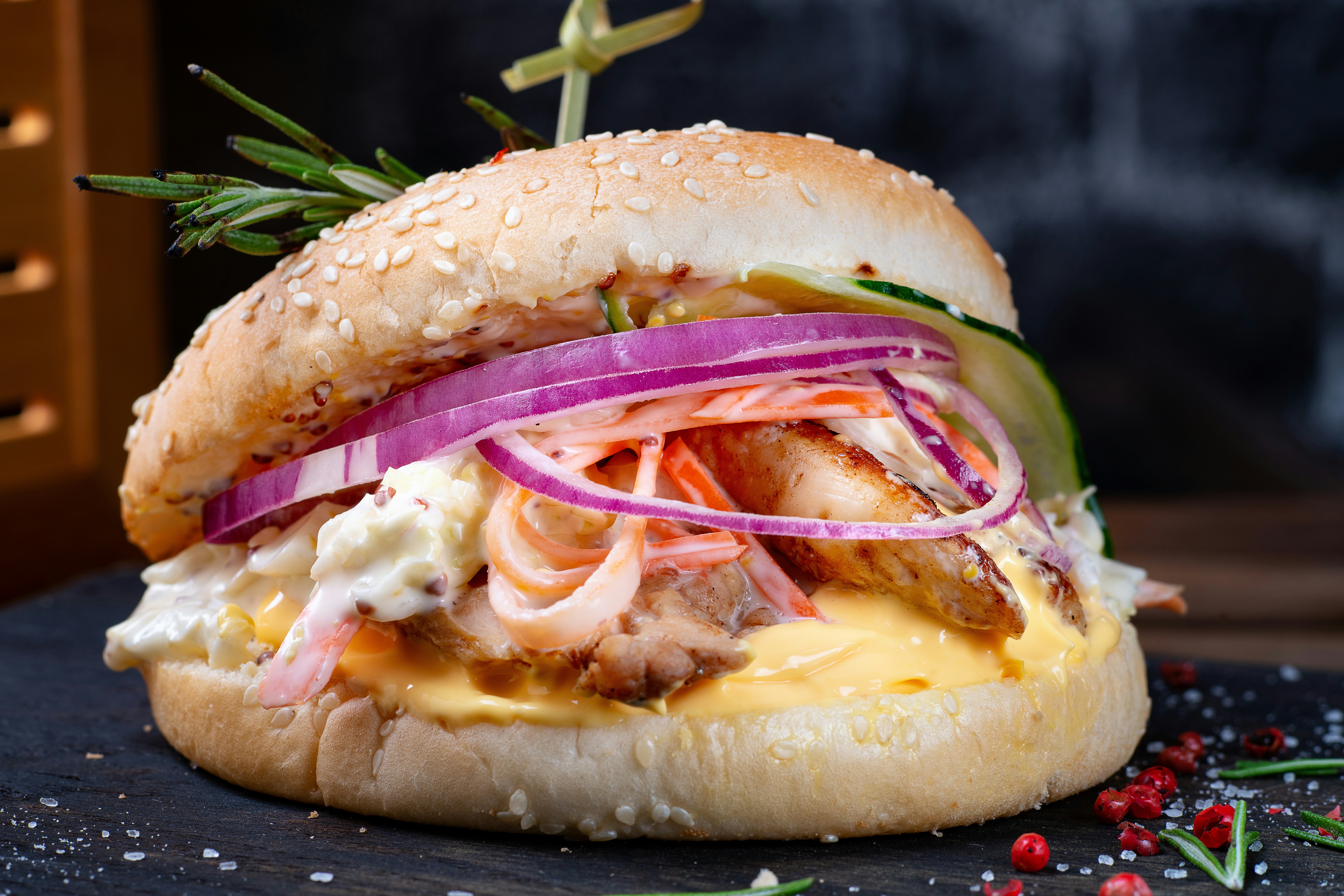 A sandwich with meat, onions, and cheese on a bun