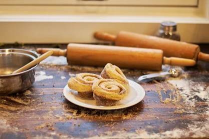 A plate of cinnamon buns on a kitchen counter
