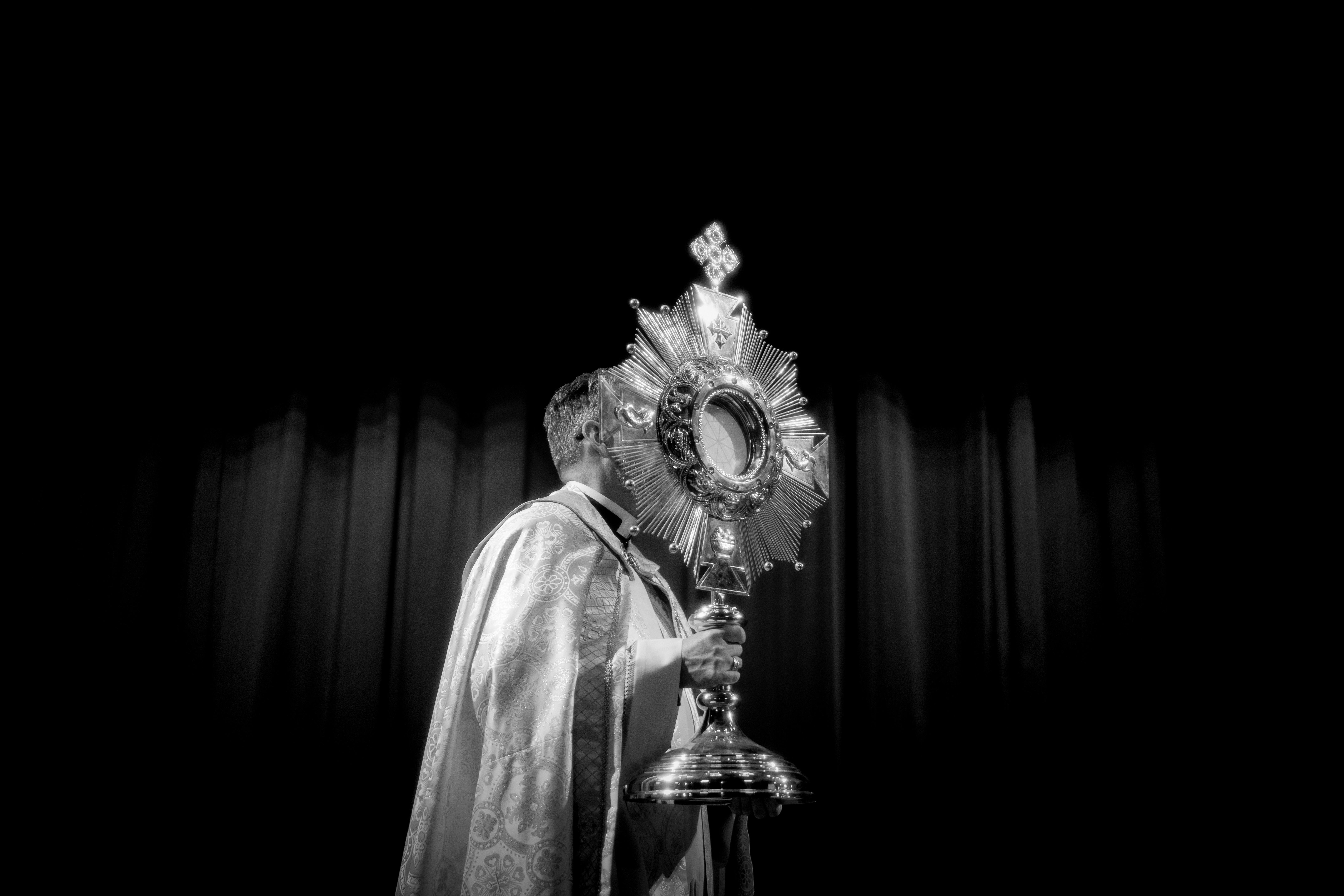 A man in a costume holding a bell