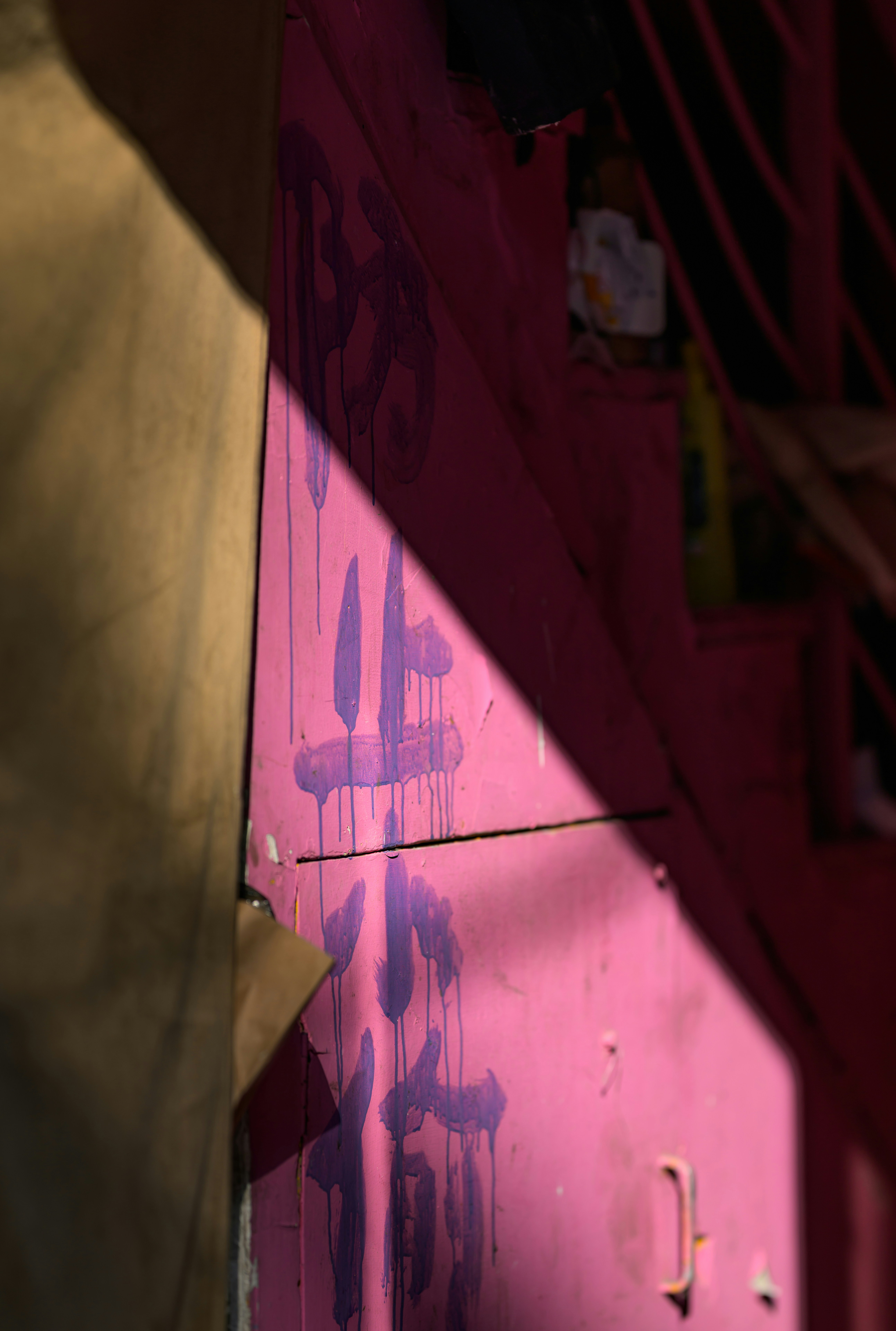 A person standing in front of a pink wall