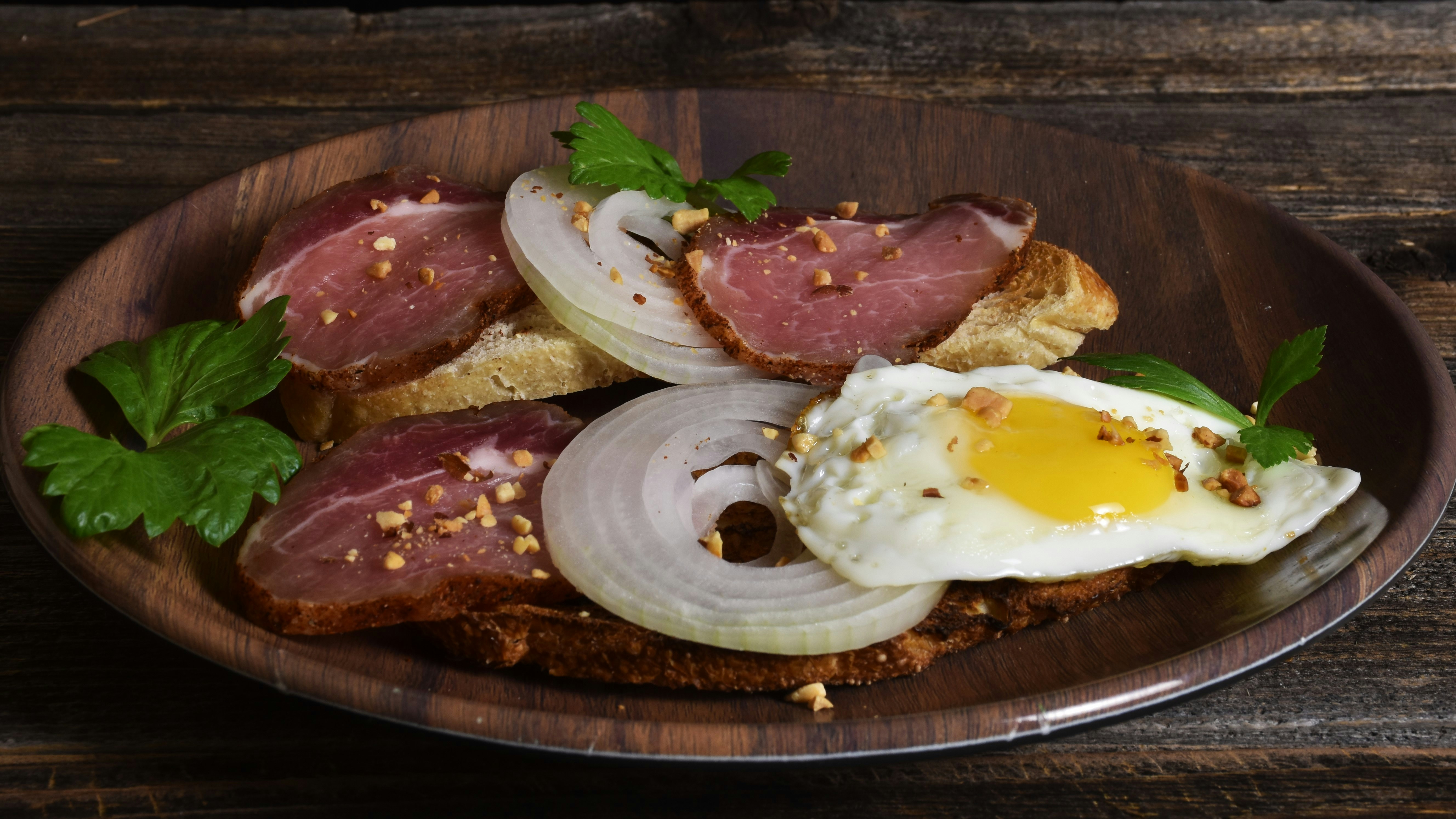 Meat with fried egg on a board