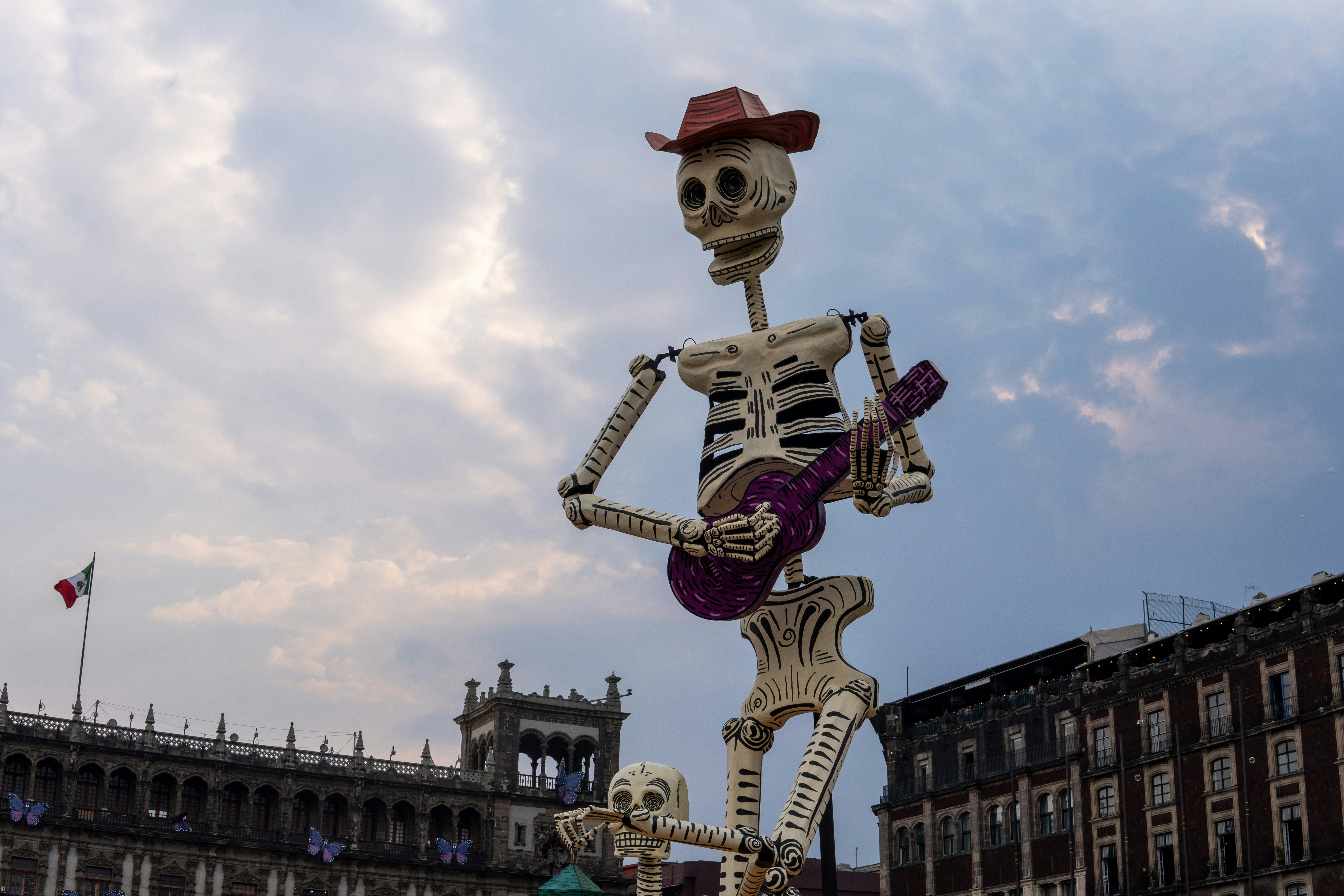 A statue of a skeleton playing a guitar