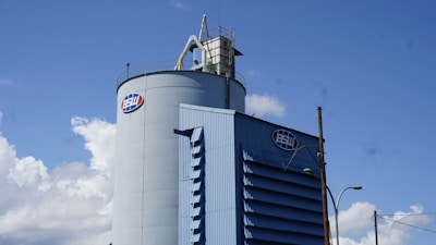 A large blue and white tower sitting on the side of a road