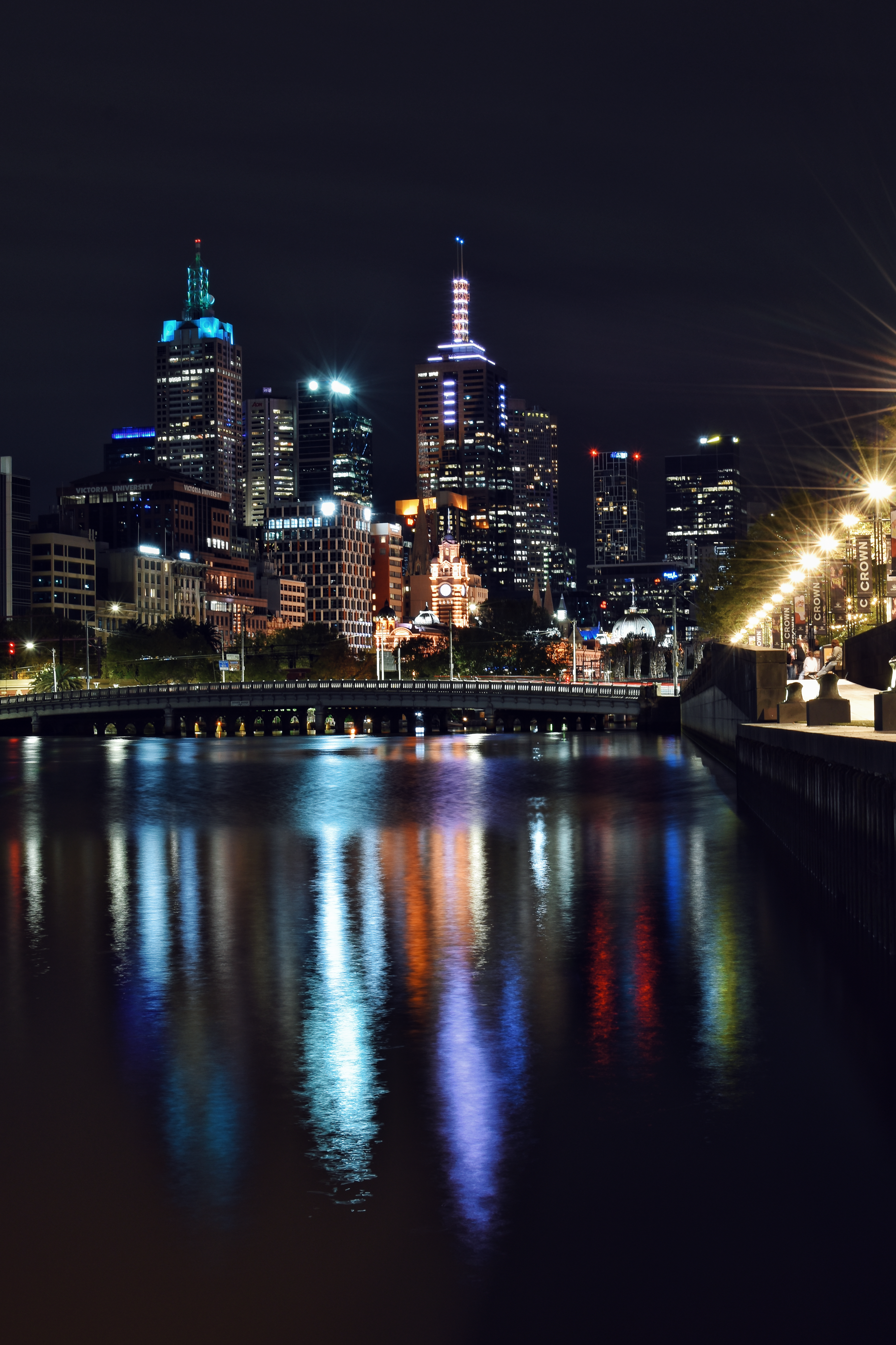 A city at night with lights reflecting in the water