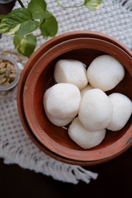 A brown bowl filled with white balls of food