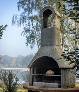 A stone oven sitting on top of a wooden table
