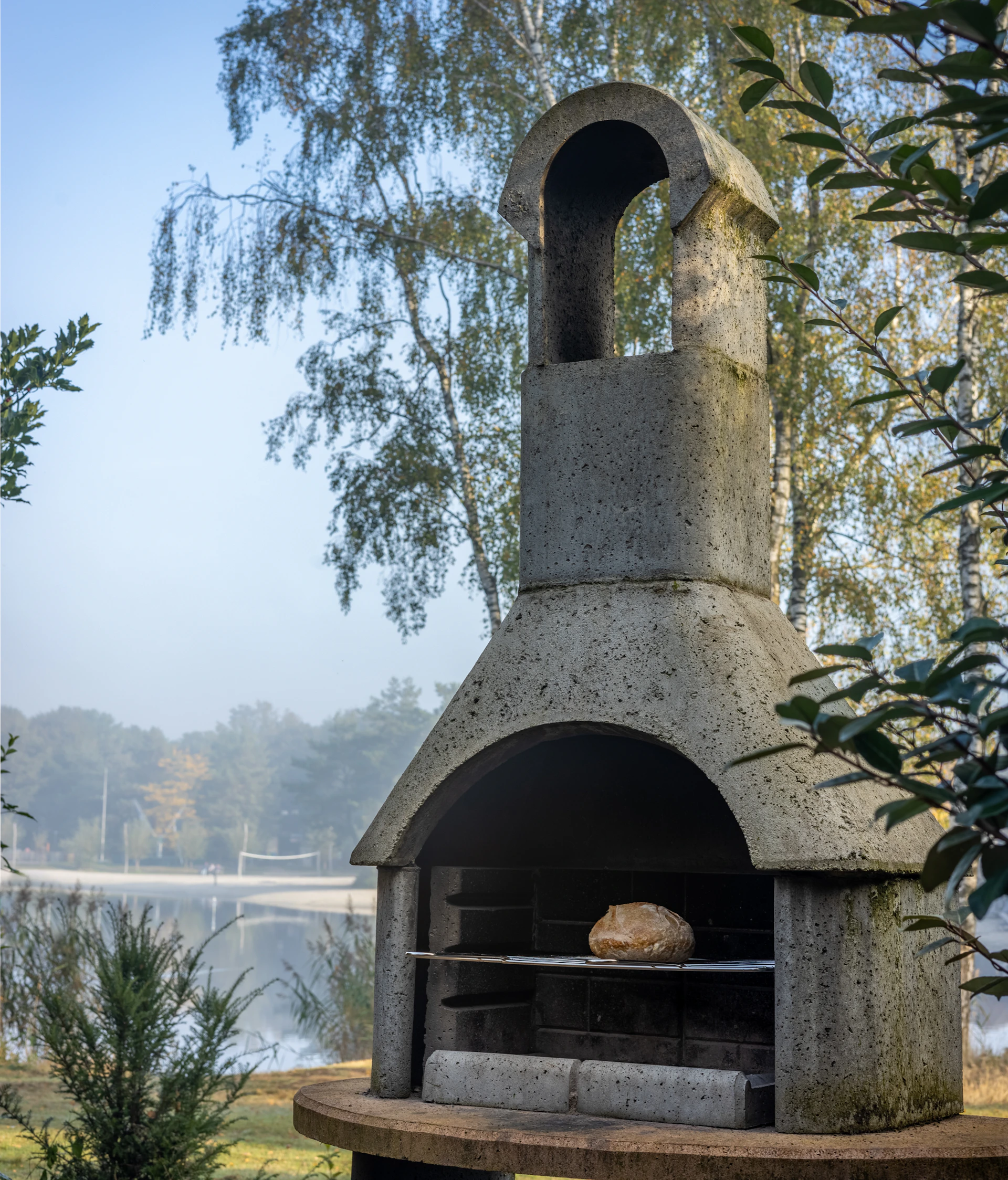 A stone oven sitting on top of a wooden table