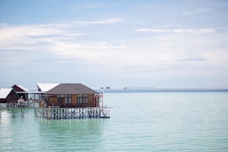 A house on stilts in the middle of the ocean