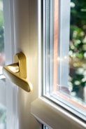 A close up of a door handle on a window