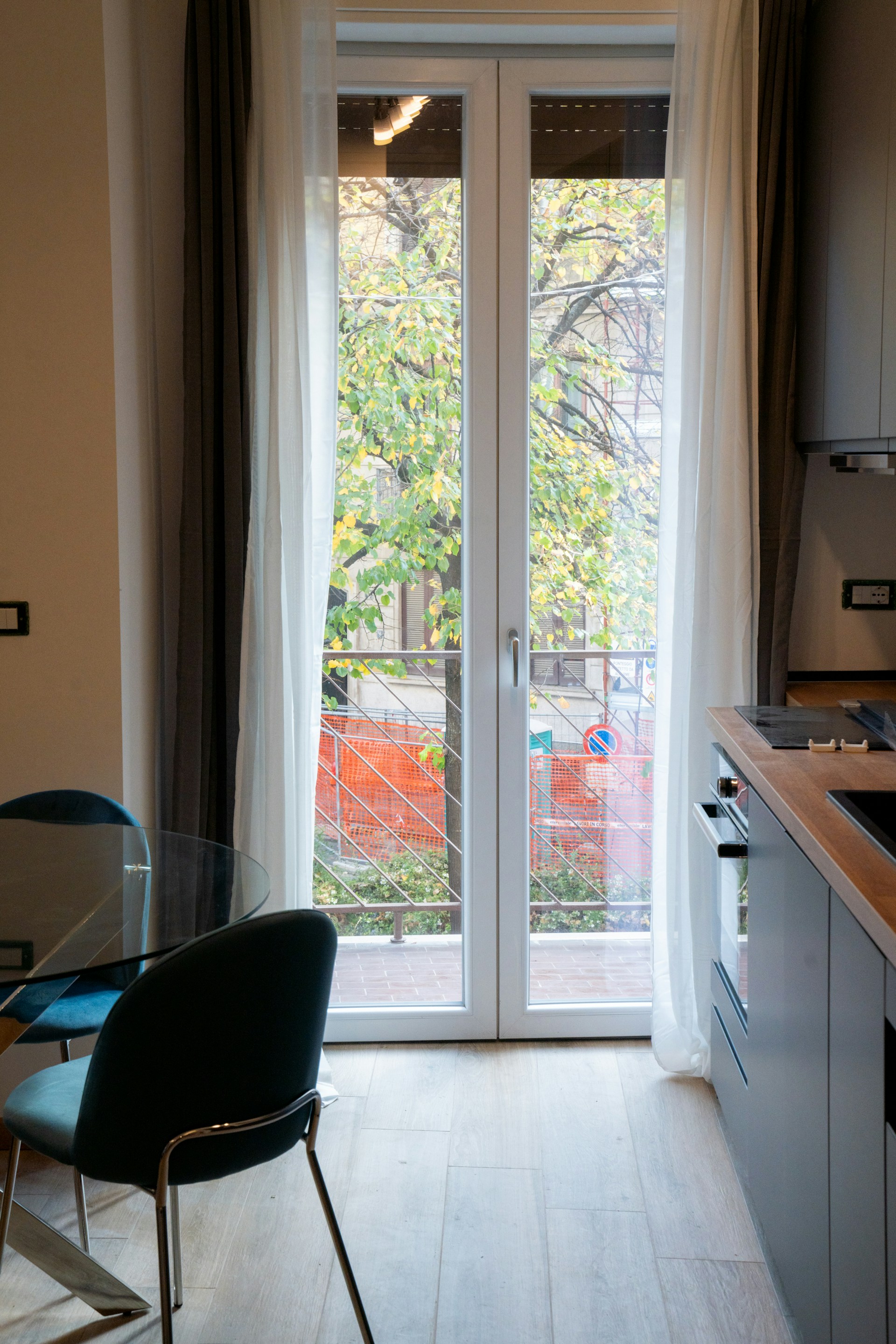 A kitchen with a table, chairs and a sliding glass door