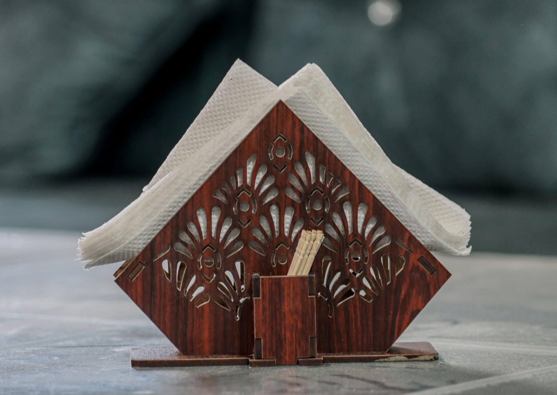 A miniature house made out of wood on a table