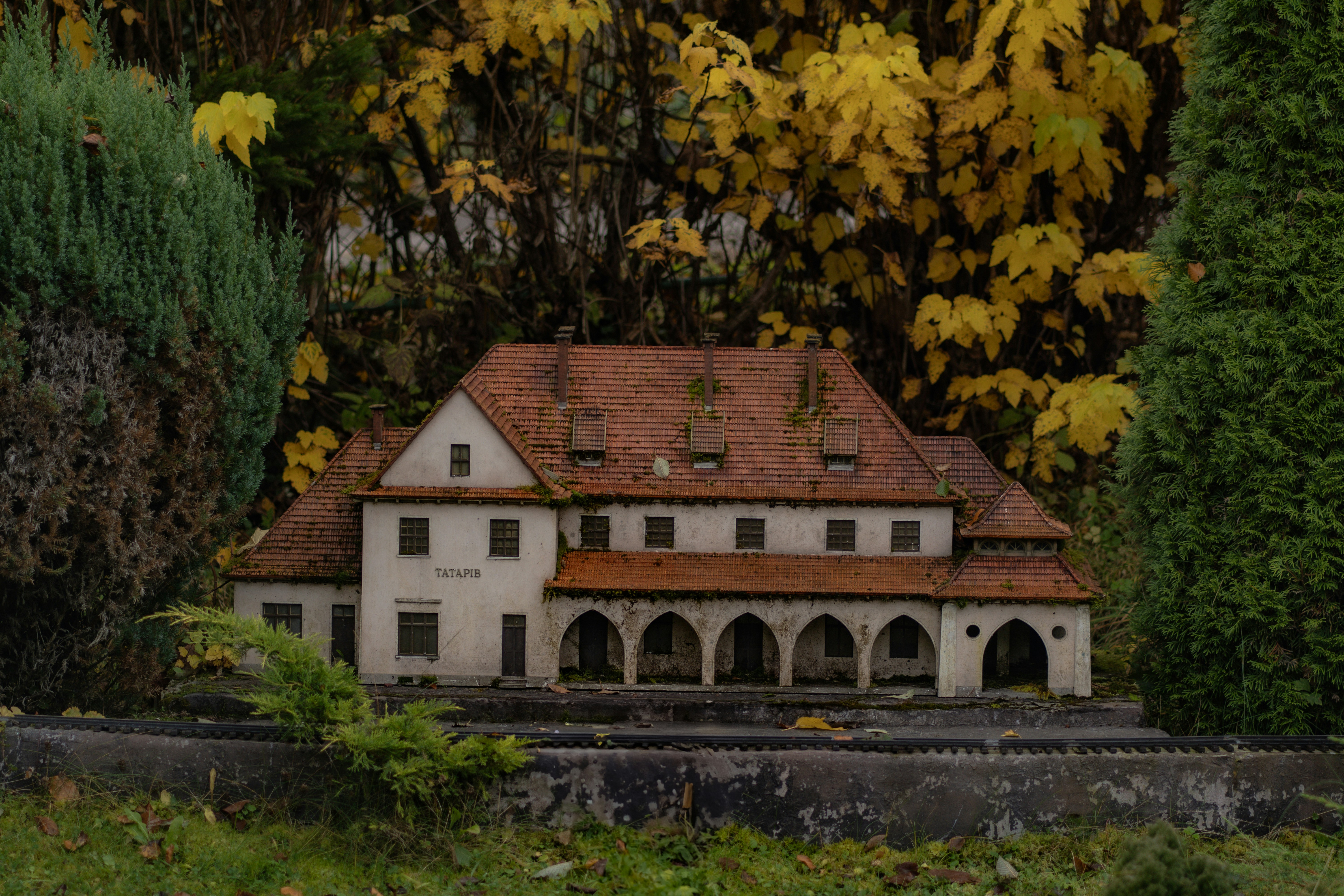 A model of a house in the middle of some trees
