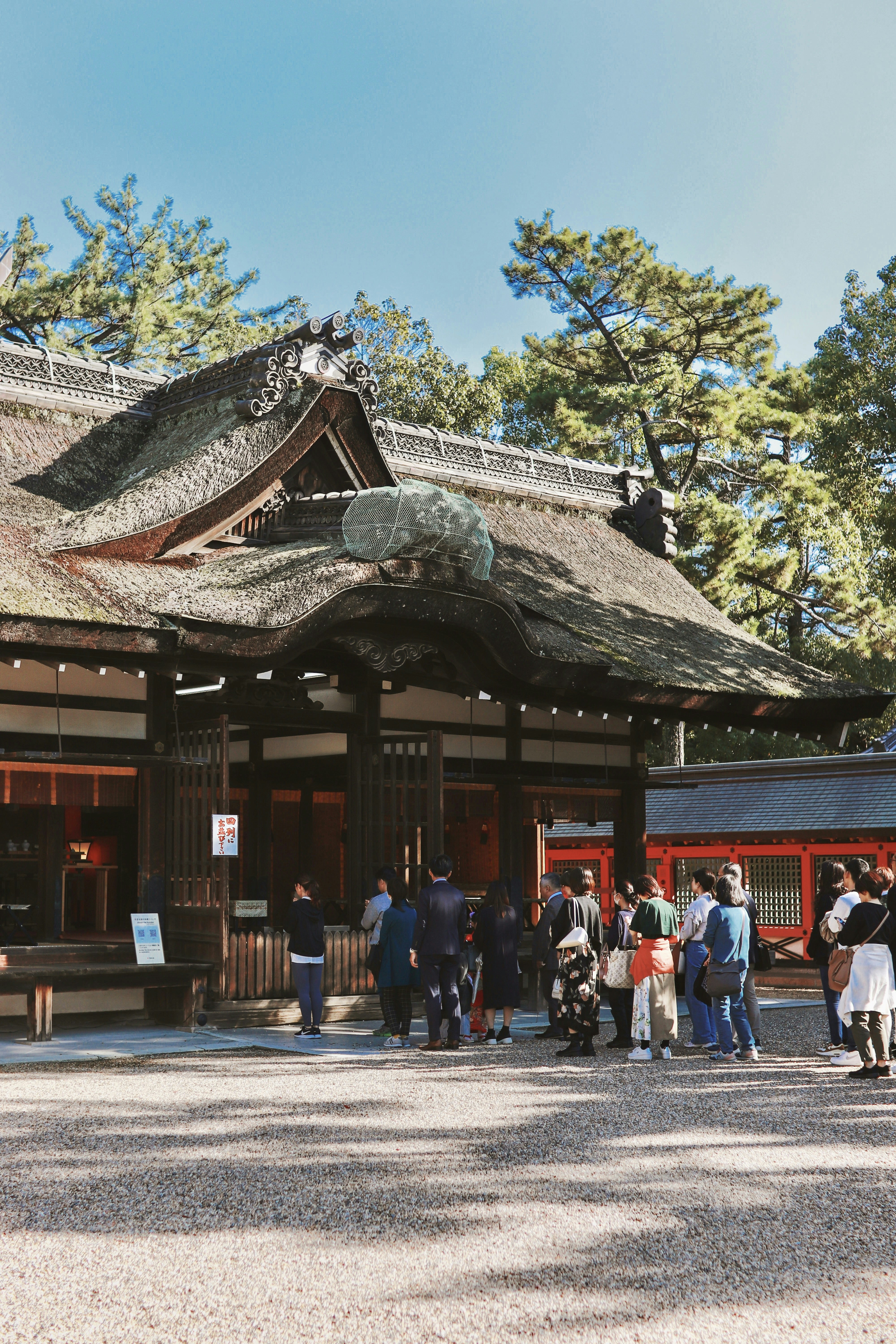 A group of people standing in front of a building