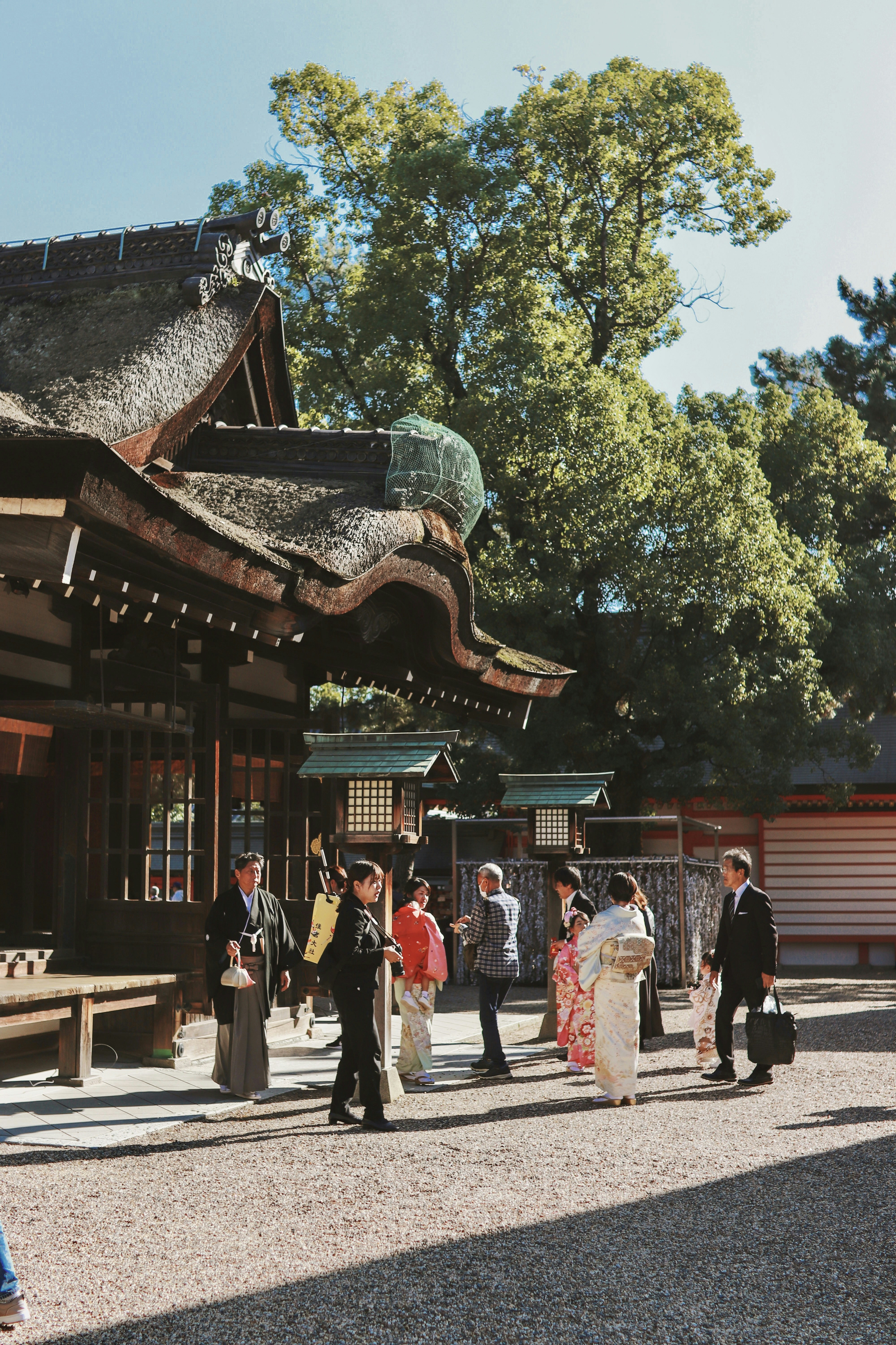 A group of people that are standing in front of a building