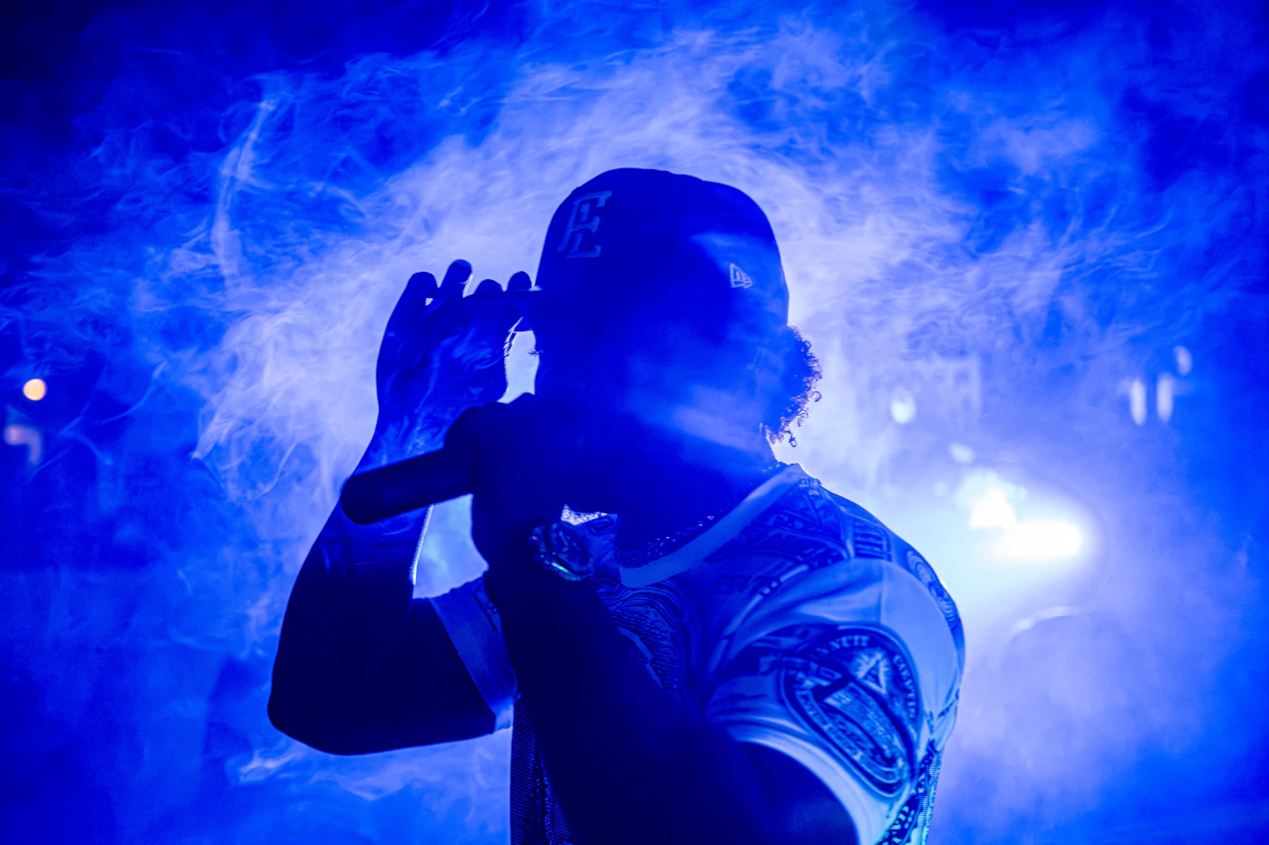 Toronto hip-hop performer surrounded by saturated blue stage haze