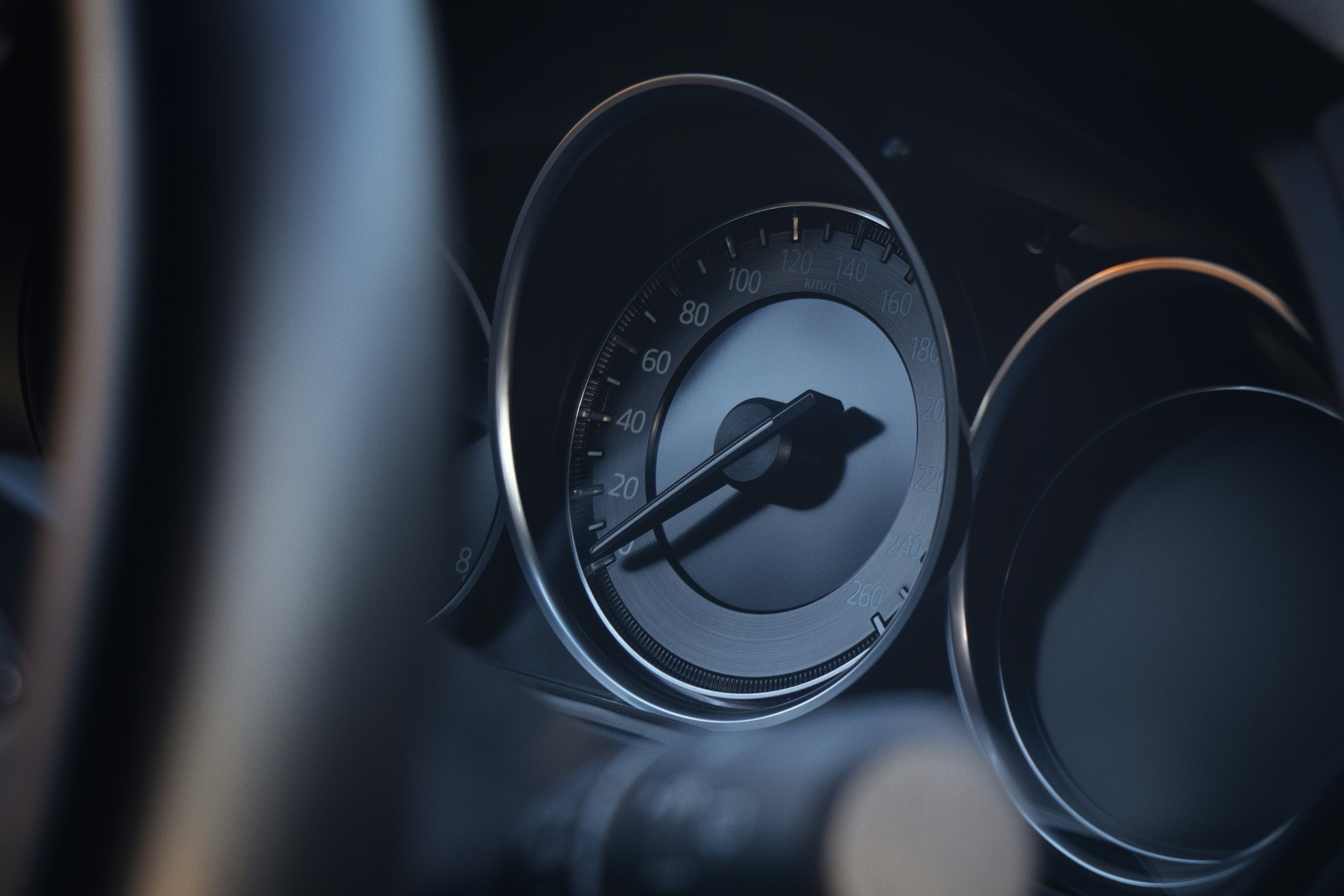A close up of a car dashboard with a speedometer