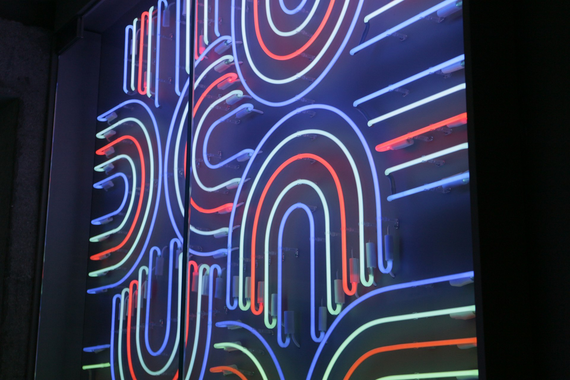 A large display of neon letters on a wall