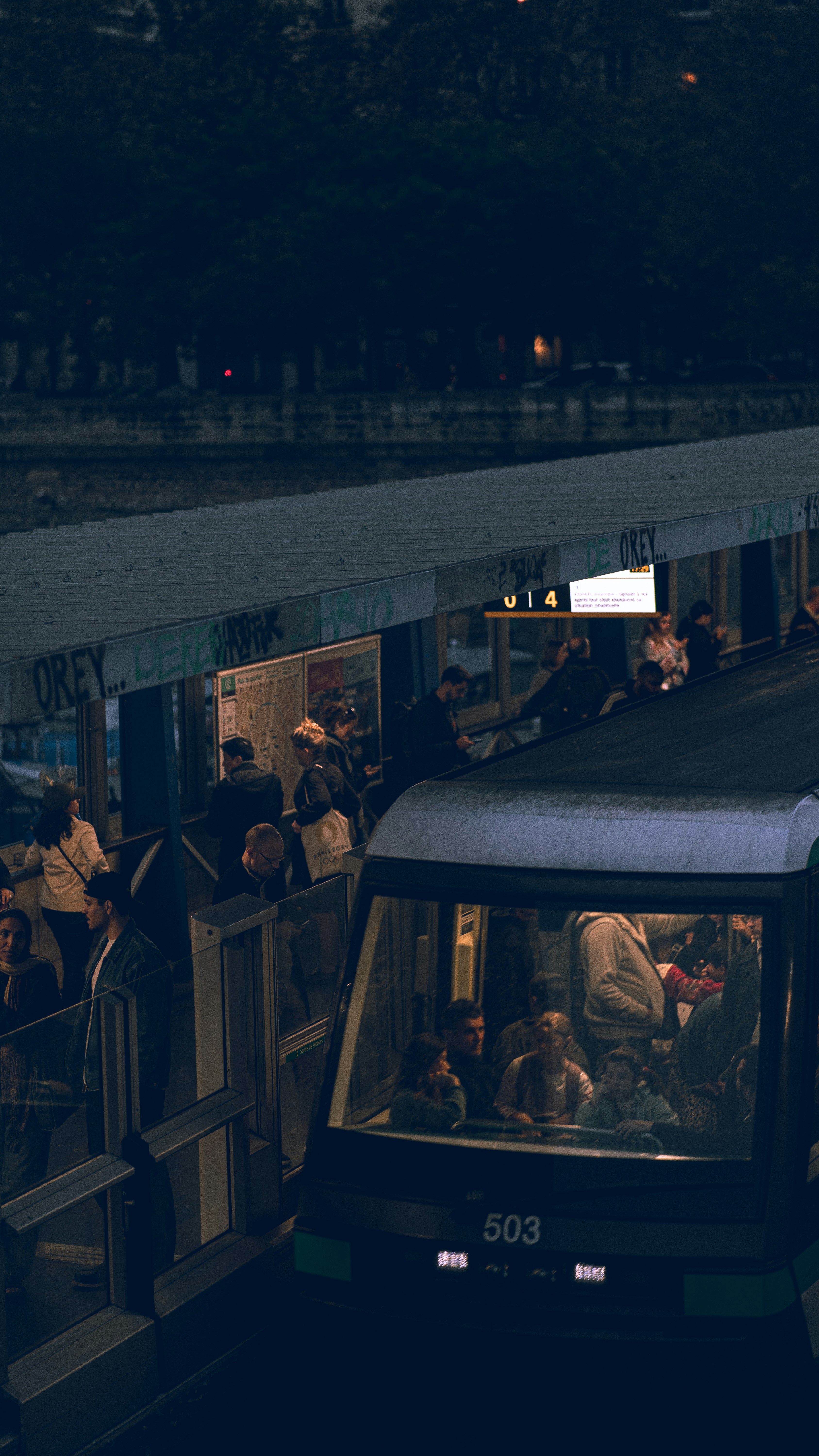 A train traveling down train tracks next to a train station