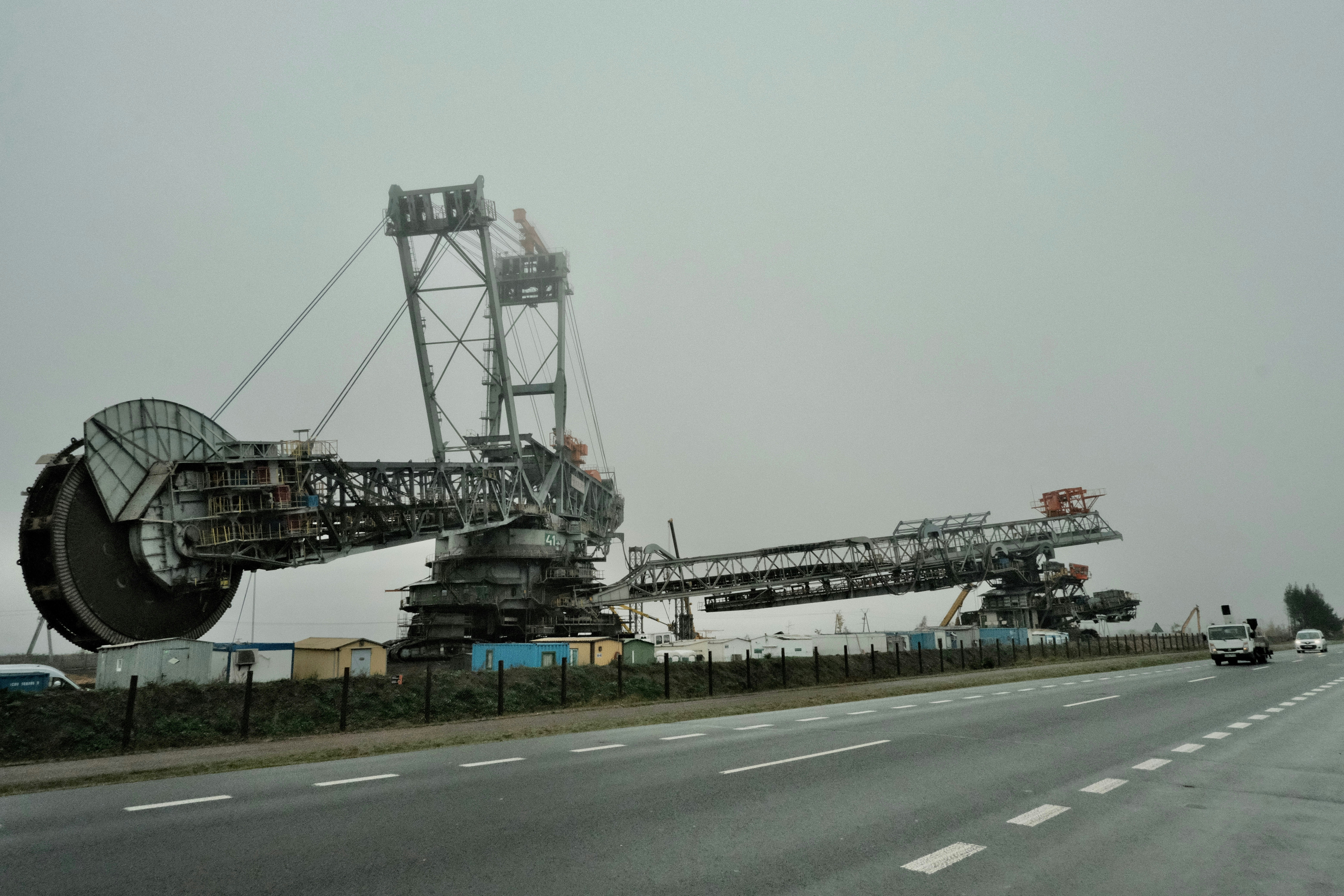 A large crane sitting on the side of a road
