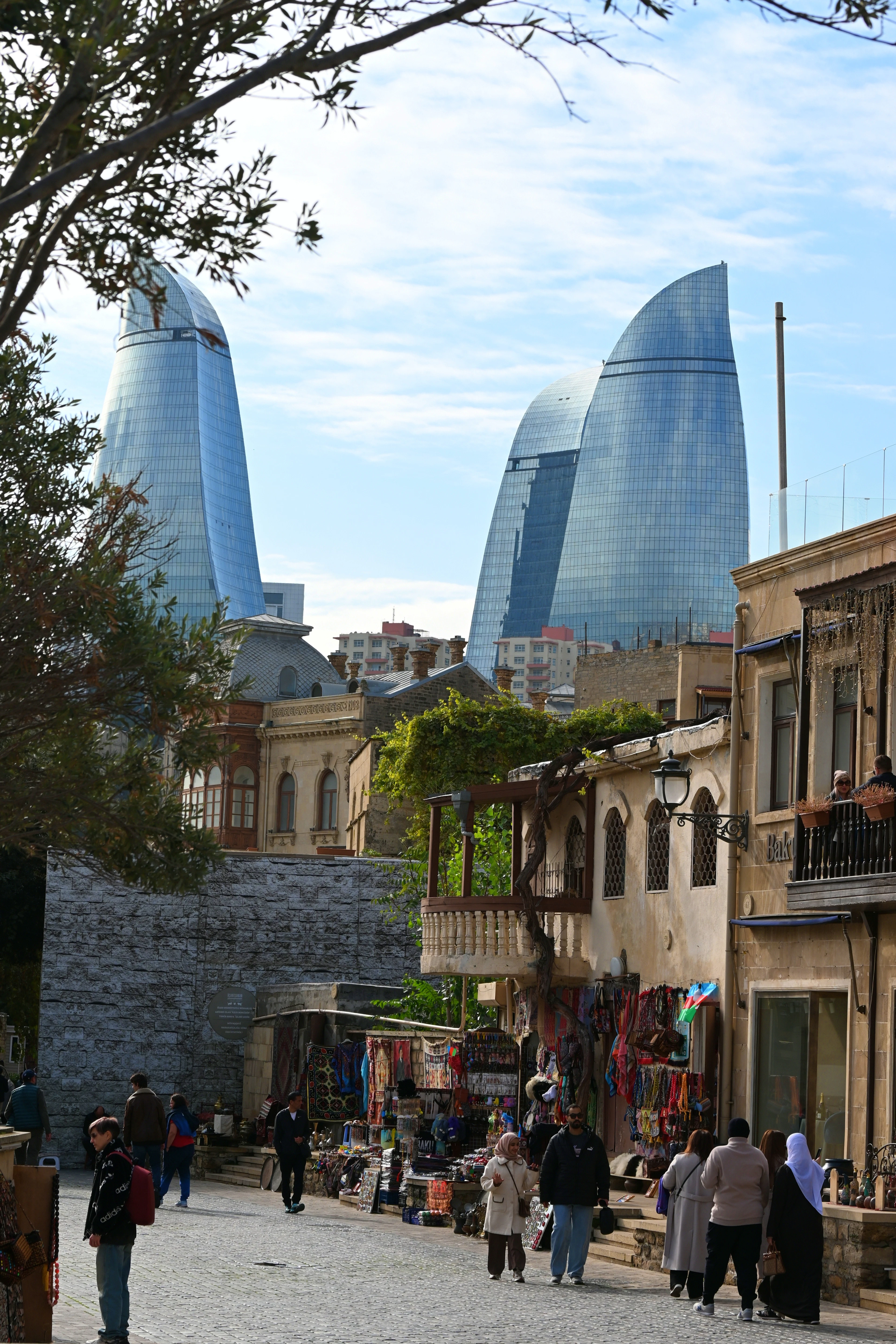 Baku's Flame Towers rise above the Old City's stone walls and a bustling souvenir bazaar.