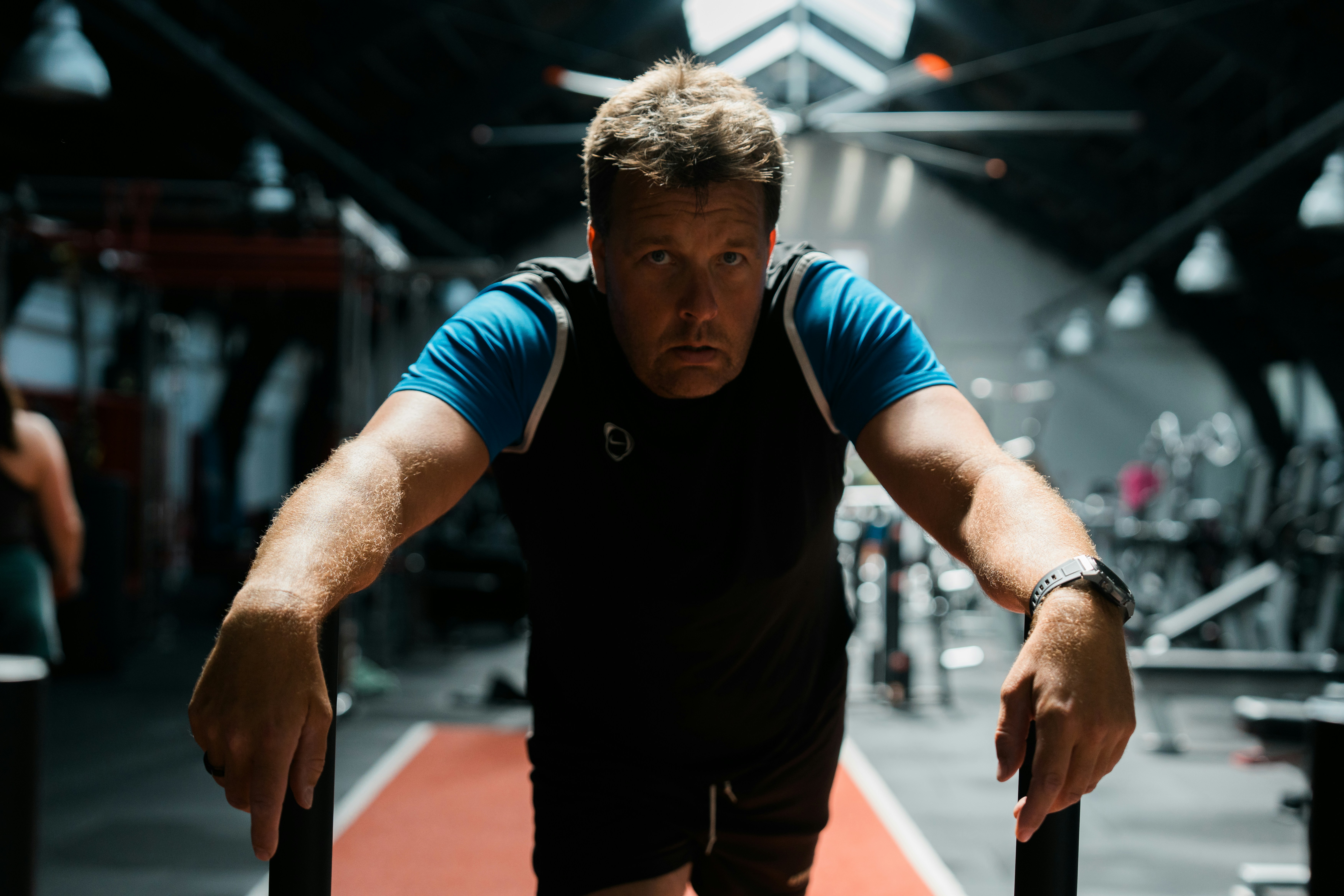 A man holding a barbell in a gym
